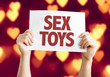 Sex Toys card with heart bokeh background