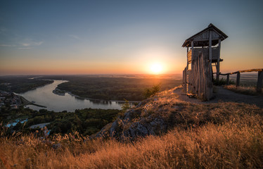 Wall Mural - Wooden Tourist Observation Tower above a Little City with River