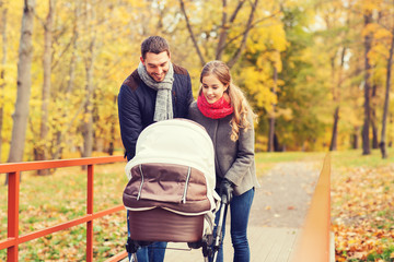 Poster - smiling couple with baby pram in autumn park