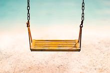 Vintage Color Tone Style Of Yellow Swing On Sand Sea Beach Summer