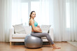 © Syda Productions - happy pregnant woman exercising on fitball at home