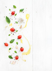 Wall Mural - Cherry tomatoes, fresh basil leaves, garlic cloves, spices and