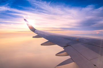 Looking through window aircraft wing during flight and look cloud in beautiful