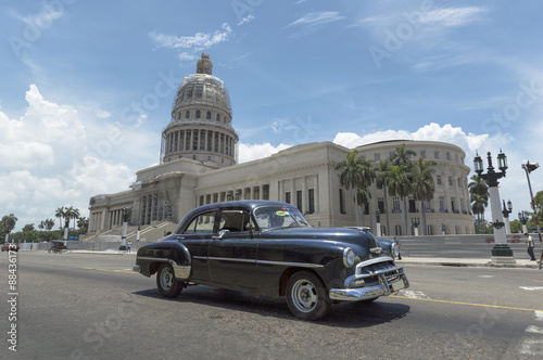 Fototapeta na wymiar Classic car in front of the Capitolio in Havana, Cuba.