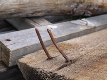 Two Rusty Curved Nails