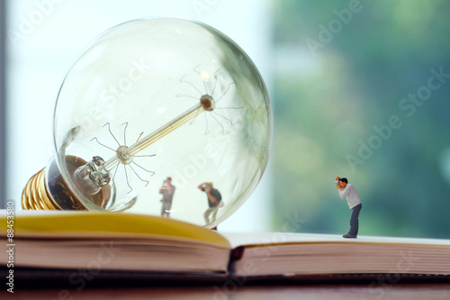 Fotografie, Obraz Creative idea concept - miniature photographer with vintage ligh