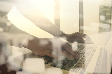 Close up of business man hand working on laptop computer with so