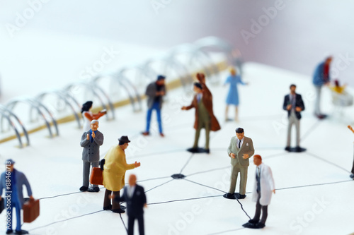 Fotografie, Obraz close up of miniature people with social network diagram on open