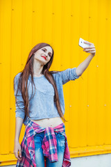 Wall Mural - Cute smiling girl making selfie