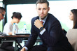 © opolja - Businessman with colleagues in the background