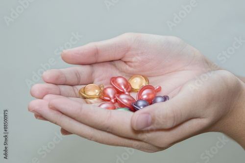 Fotografie, Obraz Hand holding hair vitamin oil serum capsule beauty care