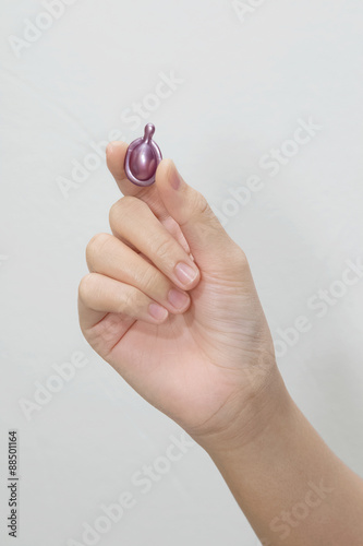 Fotografie, Obraz Hand holding hair vitamin oil serum capsule beauty care