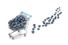 Shopping Cart Filled With Blueberries On Pure White Background With Some Blueberries Fallen Out. Healthy Shopping And Eating Concept.