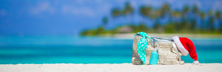 Beach accessories with Santa Hat on white tropical beach