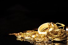 Bunch Of Gold Jewelry Against Black Background With Copy Space For Text.