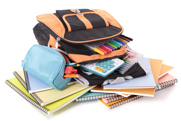 Wall Mural - School bag backpack with various books pencils crayons pencil case and study equipment isolated on white background photo