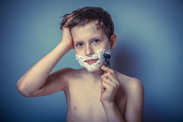 Teen boy shirtless European appearance in brown hair foam on fac