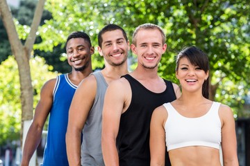 Poster - Portrait of smiling extreme athletes standing in a row