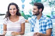 © WavebreakmediaMicro - Cute couple sitting outside at a cafe and having coffee together