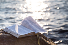 The Bible On A Stone Against The Sea
