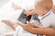 © master1305 - Young father and his nine months old son with digital tablet