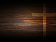 Cross on dark wooden texture