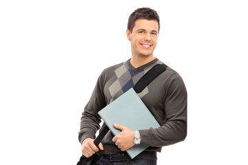 Canvas Print - Young male student holding a notebook