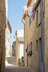 Wall Mural - narrow street with old houses and laundry in south Europe