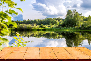 Forest lake and wooden board background