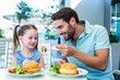 © WavebreakmediaMicro - Daughter and father eating at the restaurant