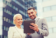 © Syda Productions - smiling businessmen with tablet pc outdoors