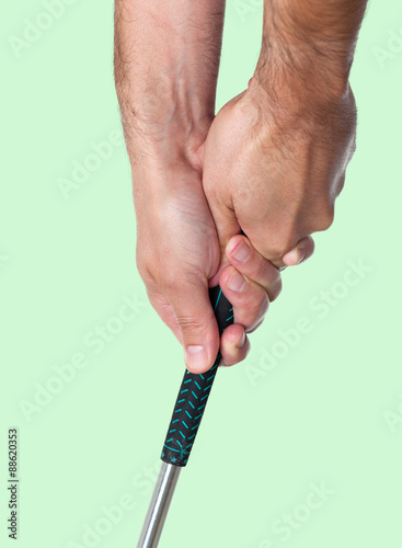 Fotografija  Man showing a two-handed golf club grip