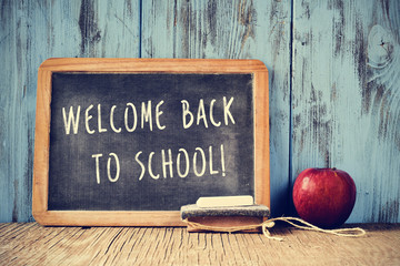 Wall Mural - text welcome back to school written on a chalkboard, cross proce