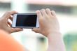 © lzf - closeup of young woman hands use smart phone in city