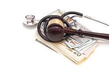 Stethoscope With Judge Gavel And Dollar Banknotes Isolated On Wh