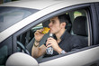 © theartofphoto - Young man driving his car while eating food