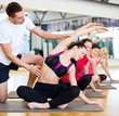 © Syda Productions - group of smiling women stretching in the gym