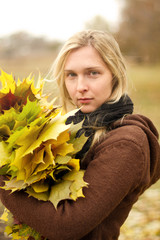 Wall Mural - Woman with autumn wreath outdoors