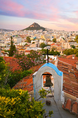 Wall Mural - View of Lycabettus hill and a small Greek orthodox church in Anafiotika, Athens.