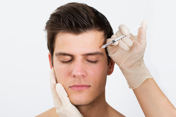 Person Hands Injecting Syringe With Botox