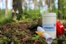 Geocaching And Geocache Container In Forest