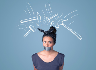 Young woman with glued mouth and hammer marks