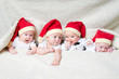 babies with santa hats on bright background