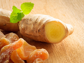 Wall Mural - Closeup root and candied ginger on wooden table