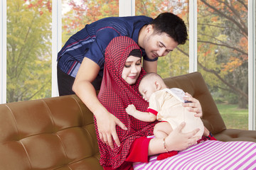 Wall Mural - Muslim parents and sleeping baby