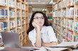 © Creativa Images - Thoughtful schoolgirl with long hair in library