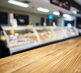 Wall Mural - Table Top counter with Blurred Fresh food Butcher display in Supermarket