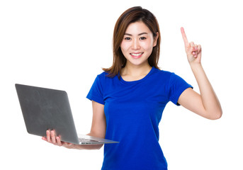 Wall Mural - Asian woman hold with notebook computer and finger point up