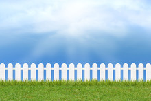 Grass And Fence Under Blue Sky And Clouds