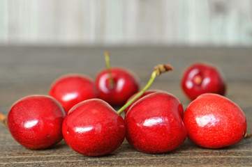 Wall Mural - Sweet cherries on wooden background